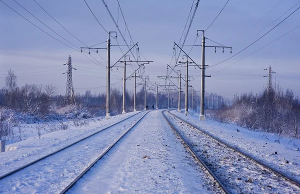 stock image Electric power lines and railway tracks in winter