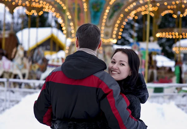 Happy couple looking at carousel — Stock Photo, Image