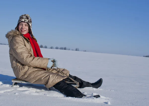Teen girl sledding from a hill — Stock Photo, Image