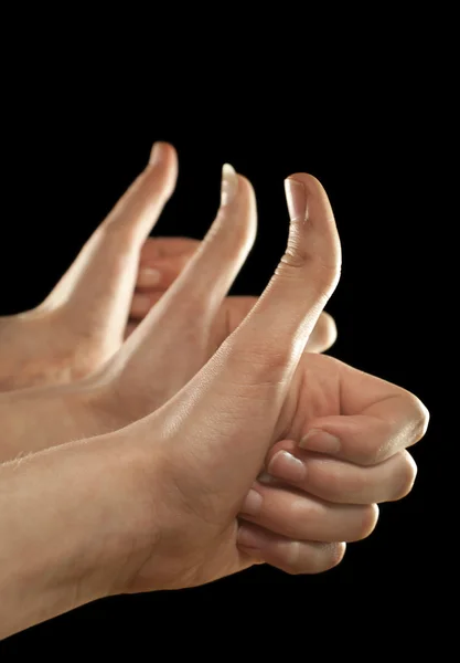 Três mãos gesticando os dedos no fundo preto — Fotografia de Stock
