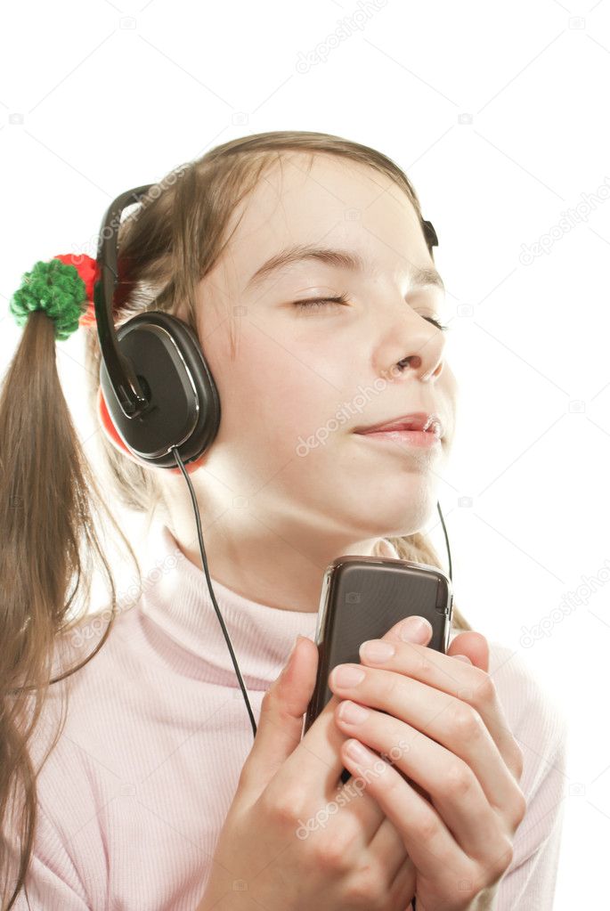Teen girl listening music isolated on white