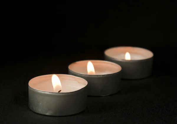 Three candles on black background — Stock Photo, Image