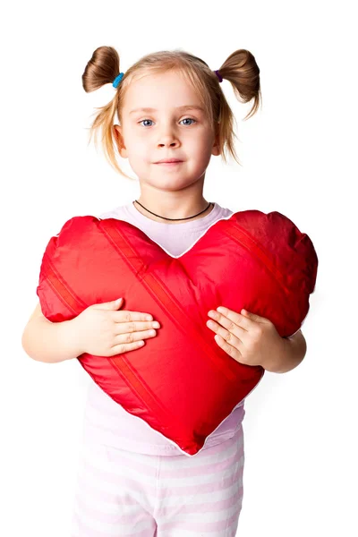Gyönyörű lány, szív alakú párna — Stock Fotó
