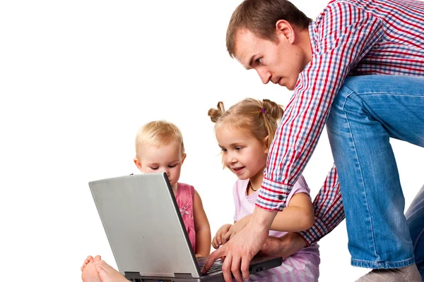 Отец с детьми играет на ноутбуке — стоковое фото