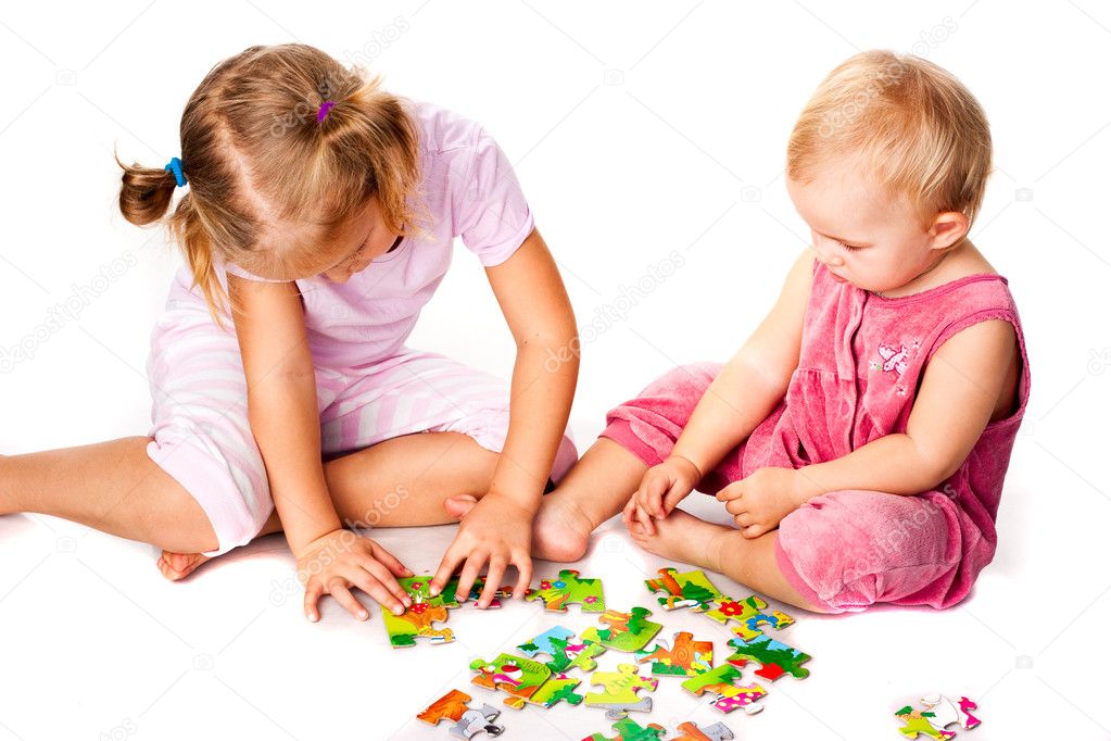 Children solving jigsaw puzzle