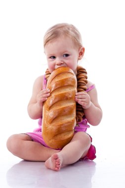 Baby biting a loaf of bread in roll beads clipart