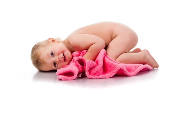 Красивая девушка свернувшаяся на розовом одеяле — стоковое фото