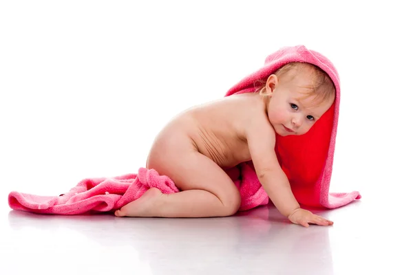 Beautiful girl curled under a pink blanket — Stock Photo, Image