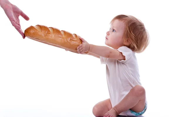 Baby giving out a loaf of bread — Stock Photo, Image