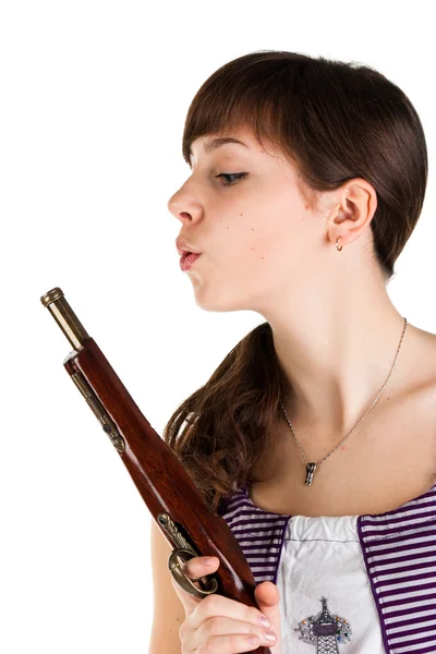 Beautiful girl blowing on a gun — Stock Photo, Image