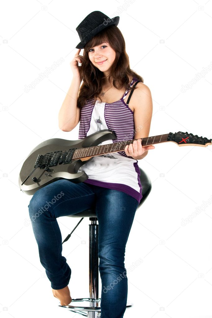 Beautiful girl playing the guitar isolated on white