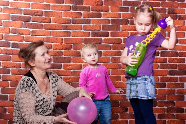Grandmother playing with her grandchildren — Stock Photo, Image