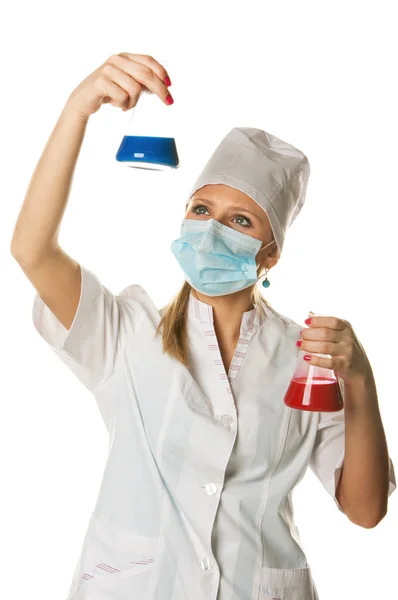 Young female scientist holding two color flasks - isolated on white — Stock Photo, Image