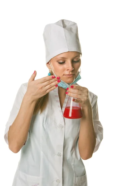 stock image Young female scientist holding red flask - isolated on white