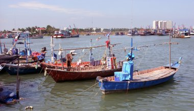 Cha am harbour in Thailand with moored fishing boats clipart