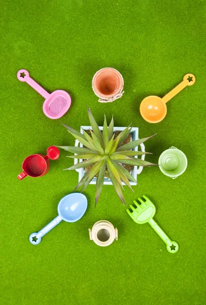 Garden tools on the fake grass — Stock Photo, Image