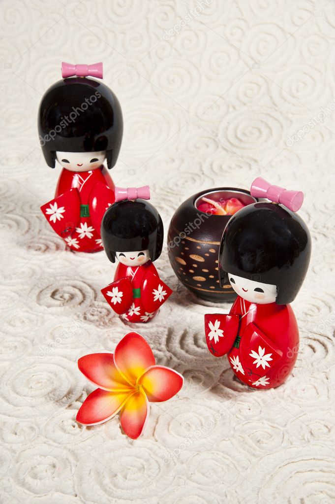 Trhee Japanese dolls on paper background