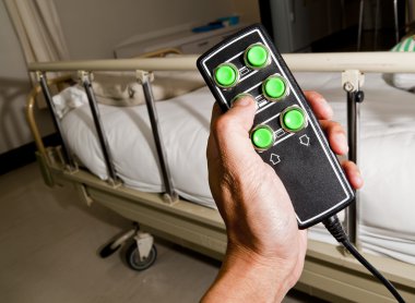 Remote control of patient bed in the hospital clipart