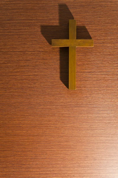 Brown Wooden cross on the wooden wall — Stock Photo, Image