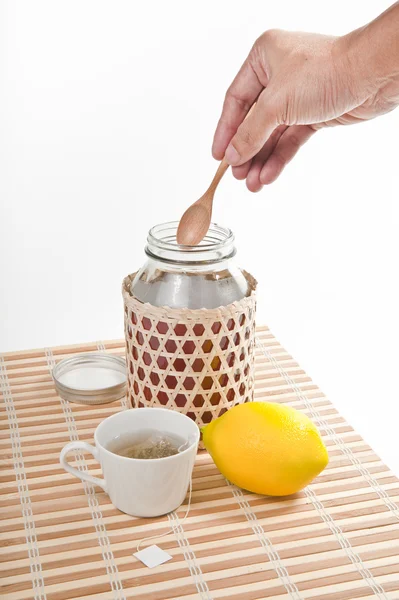 stock image Putting honey in the cup of tea