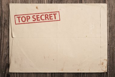 Open top secret envelope on table. clipart