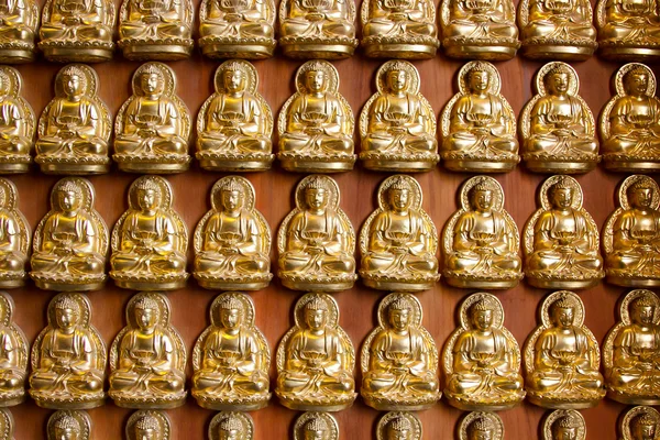 Small buddha statues as background — Stock Photo, Image