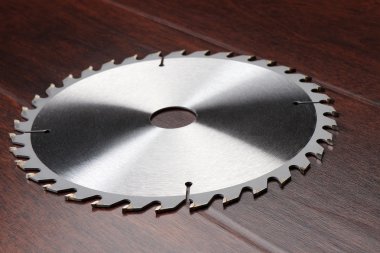 Circ saw blade on dark background clipart