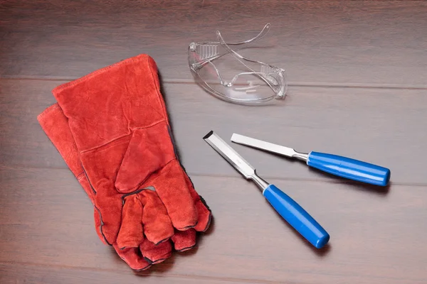 stock image Red gloves, glasses and blue chisels