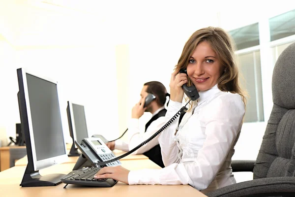 Young girl at office on the workplace makes call — Stock Photo, Image