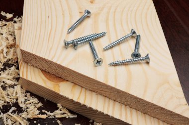 Several screws on wooden planks clipart