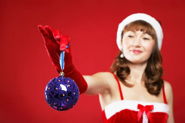 Молодая очаровательная девушка в костюме Санта-Клауса держит в руках подарок в виде сердца. — стоковое фото