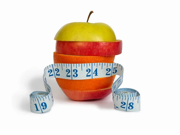 stock image Slices of apples and orange as one fruit and a measuring tape