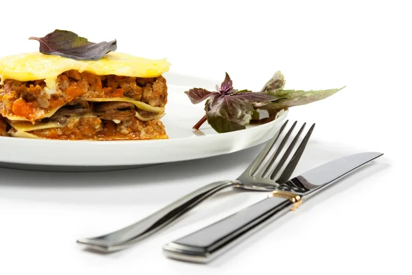 Lasagne med basilika Stockfoto