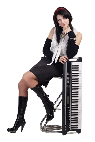 stock image Beautiful girl sitting with synthesizer isolated