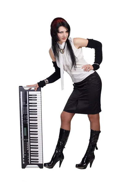 Beautiful girl staying with synthesizer isolated — Stock Photo, Image