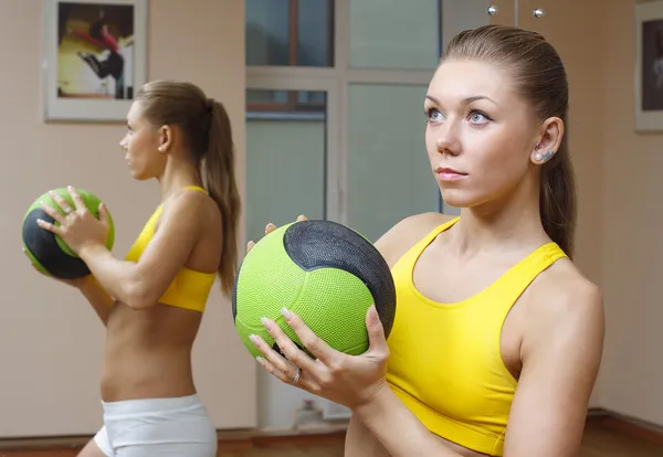 Girl with ball mirror background fitness gym — Stock Photo, Image