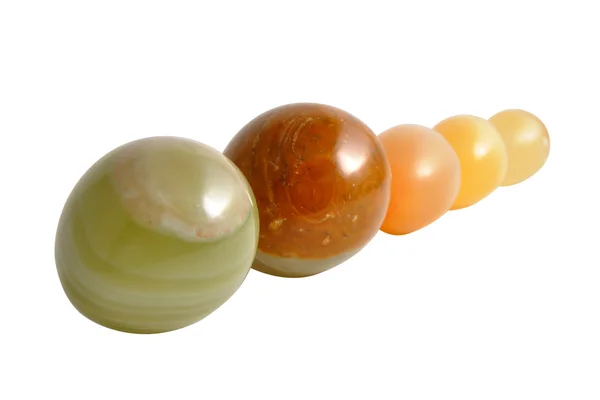 Stone balls in a row on a white background — Stock Photo, Image