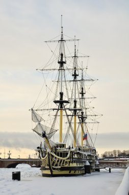 Sailing vessel on the waterfront, winter, ice, snow clipart