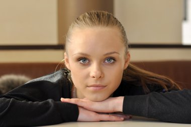 Portrait of a young beautiful girl with blue eyes clipart