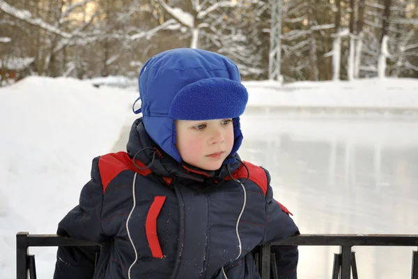 Sad little boy at the ice rink — Stock Photo, Image