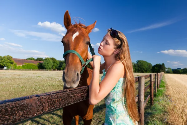 Horse and blond girl in paddock on summers — Stock Photo, Image