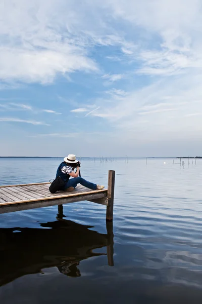 stock image The photographer working on the lake