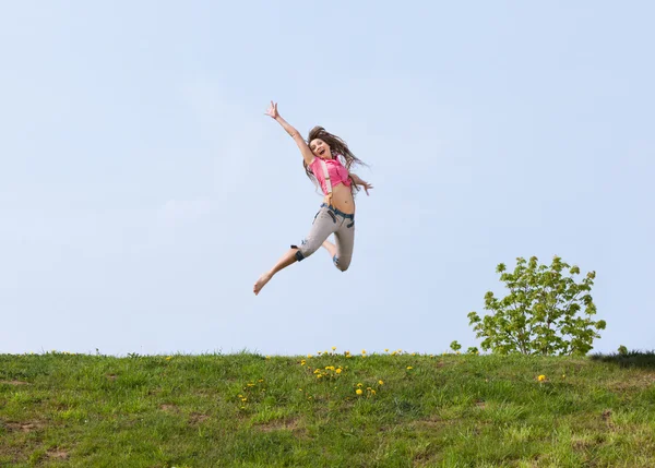 Happy young woman jumping — Stock Photo, Image