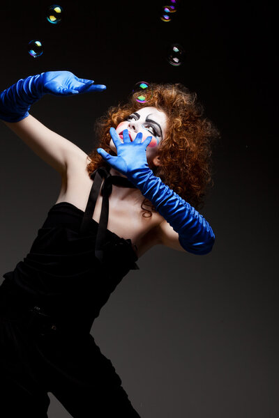 Woman mime with soap bubbles.