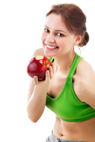 Женщина в спортивной одежде с яблоком — стоковое фото