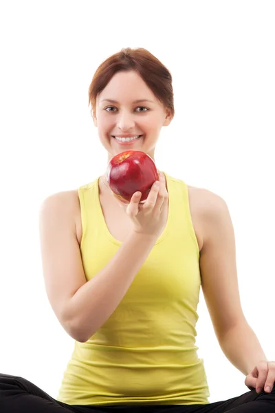 Woman in sportswear with apple — Stock Photo, Image