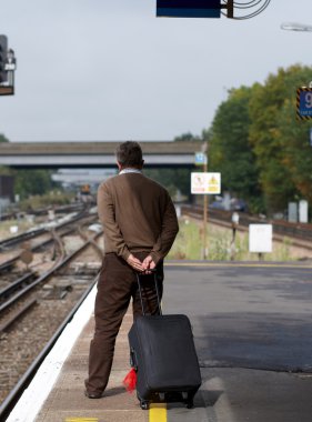 Man on railway station clipart