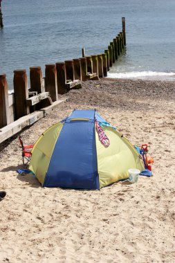 Beach tent at water edge clipart