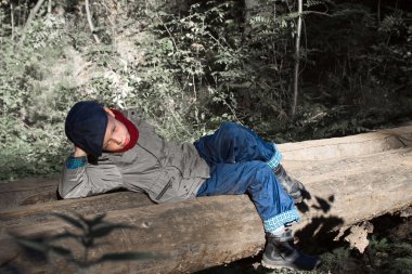 Boy lying on the bridge clipart