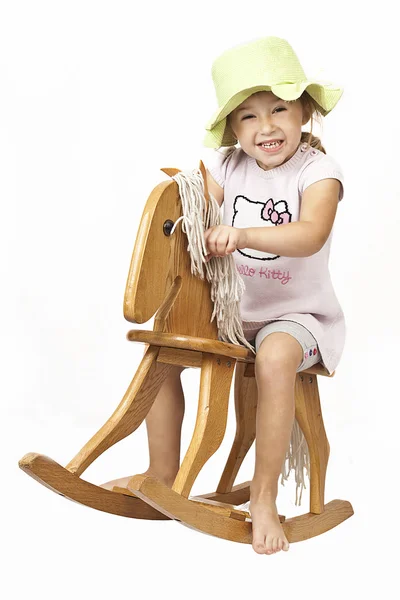 Little girl and rocking horse — Stock Photo, Image
